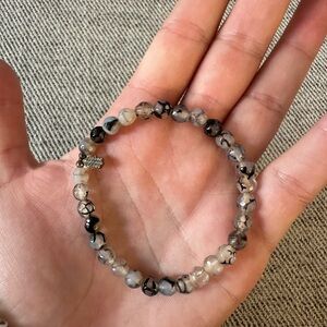 Grey and blue toned beaded bracelet with hamsa hand charm